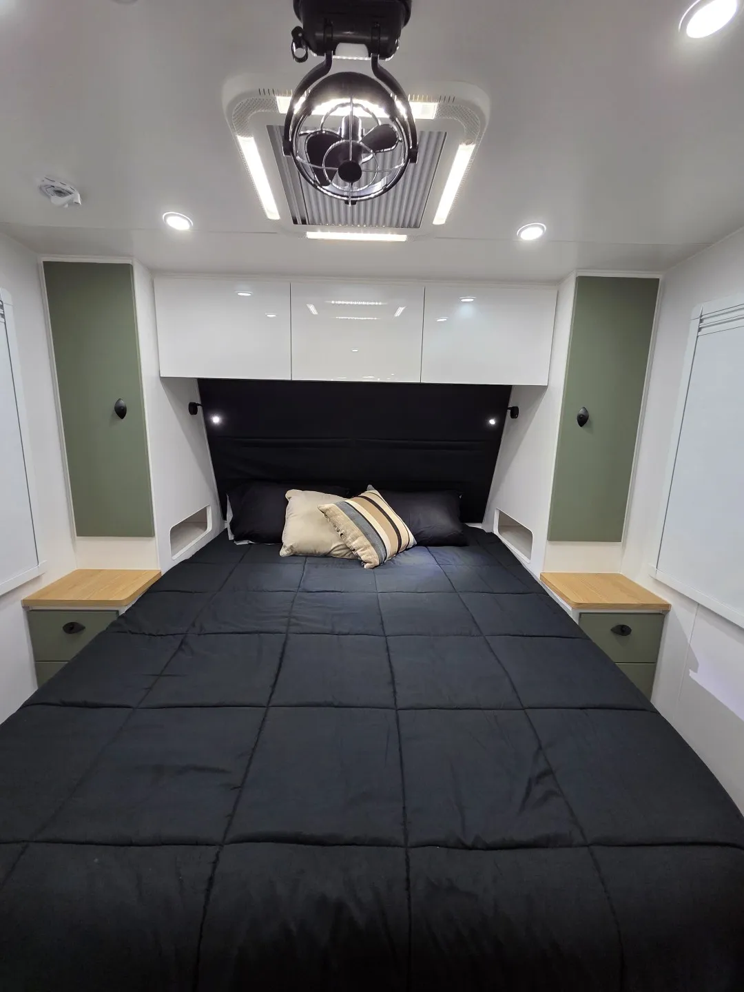 Safari Delta 20 Rear Club queen bed with overhead cupboards and bedside tables