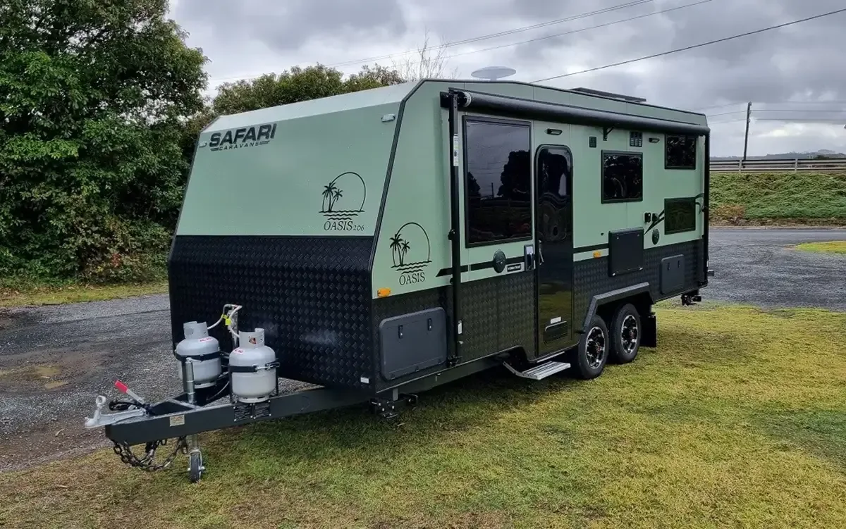Safari Oasis 206 Bunks in sage green, front three-quarter view with two gas bottles on the A-frame