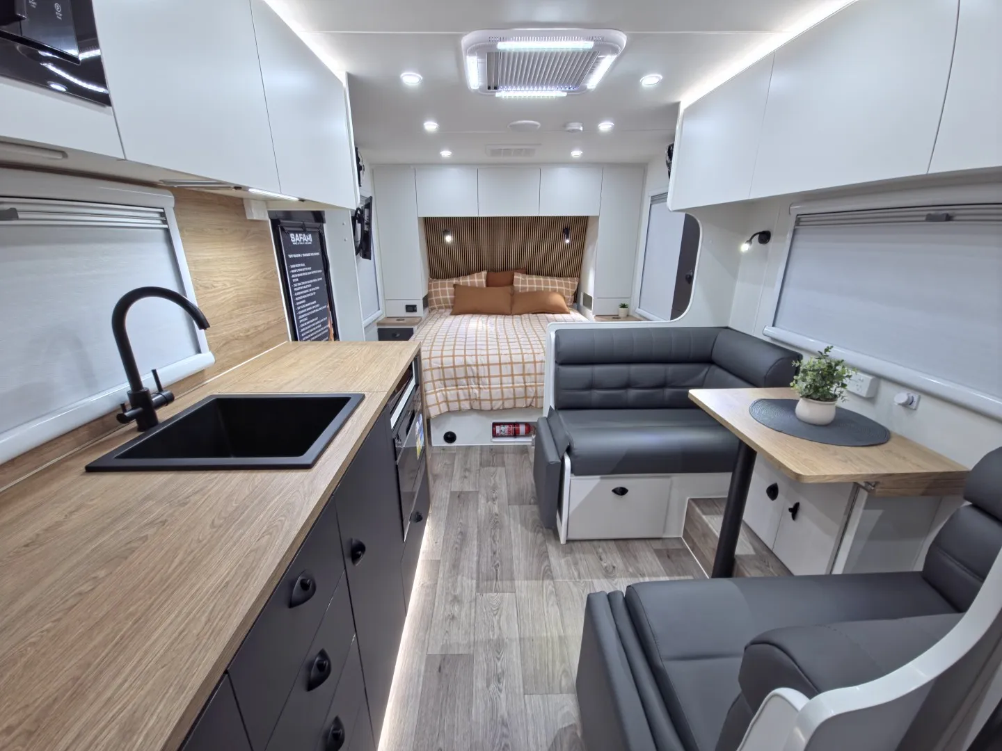 Safari Tuff Roader-X 206 interior with kitchen, dinette and bed at the rear