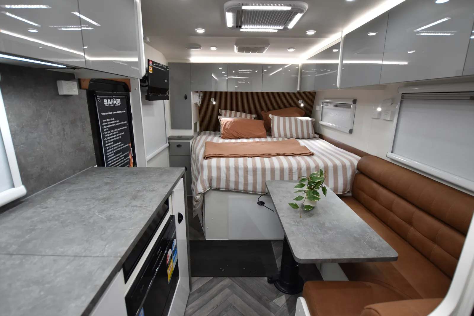 Safari Tuff Roader-X 226 King Bed interior with kitchen, tan dinette and king bed