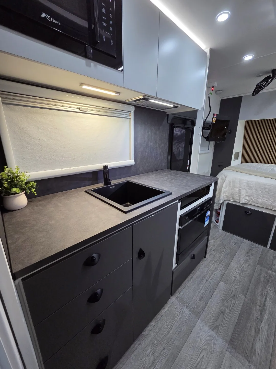 Safari Tuff Roader-X 228 kitchen with black sink, oven and overhead cupboards