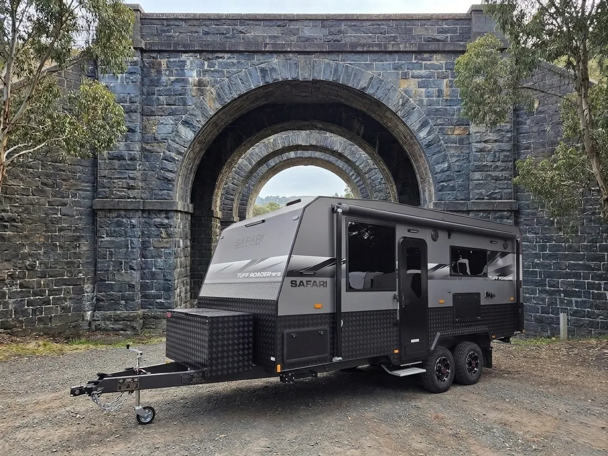 Safari Tuff Roader 1810 in grey parked beneath a bluestone railway bridge