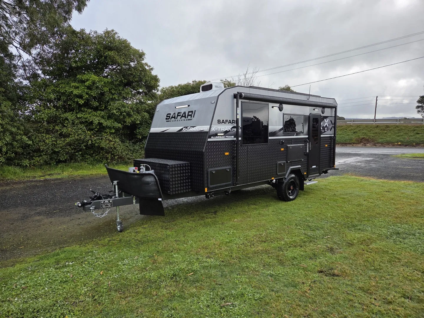 Safari X-Trak 176 caravan on grass with the front toolbox and stone guard