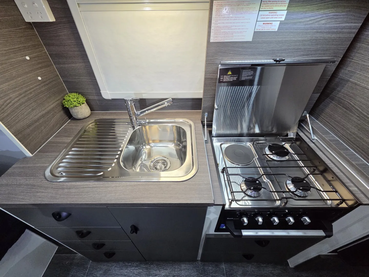 Safari X-Trak 176 kitchen with stainless sink and four-burner cooktop