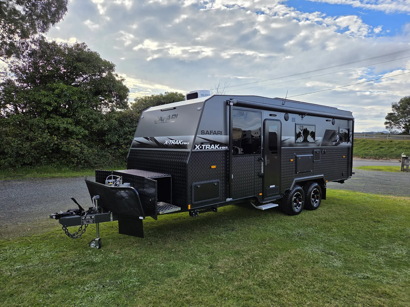 Safari X-Trak 216 KE caravan parked on grass, front three-quarter view