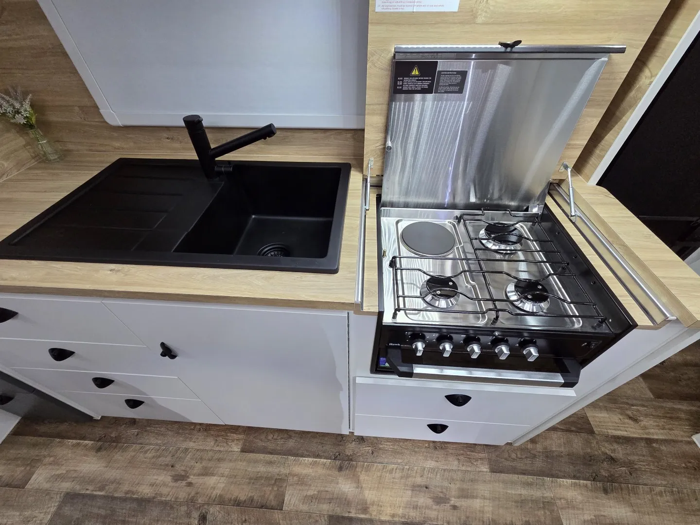 Safari X-Trak 216 KE kitchen with black sink, timber benchtop and cooktop