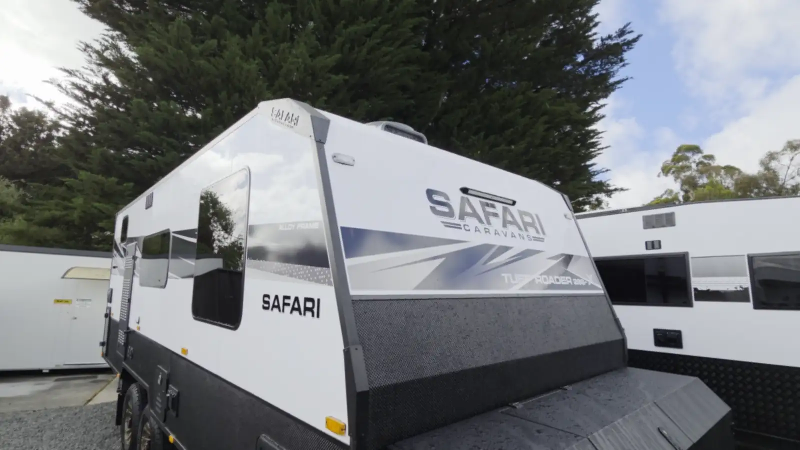 The front of a Safari caravan parked in the yard